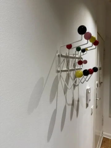 Loose designer coat rack repaired