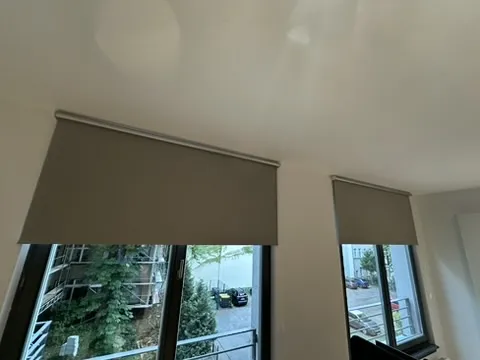 Two fitted roller blinds above the windows.