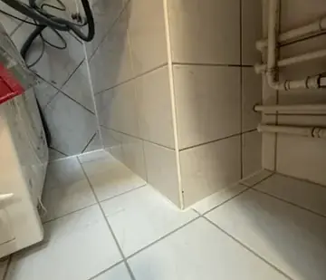 Derselbe Bereich unter dem Waschbecken nach Reinigung, Behandlung und Erneuerung der Silikonfugen.