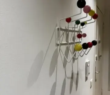 The coat rack mounted against the hallway wall after the later repair visit.